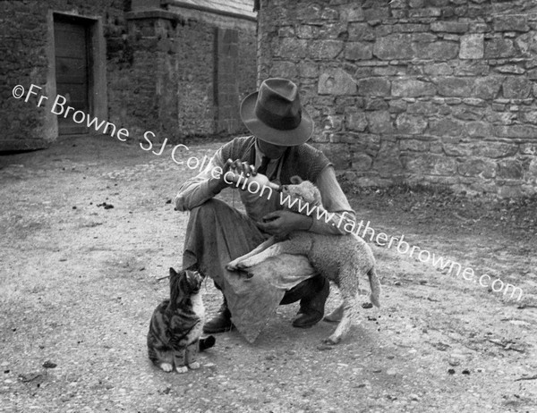 MAN BOTTLE FEEDING LAMB